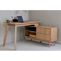 a wooden desk with a laptop on it