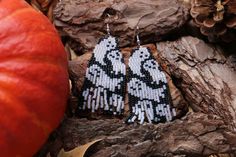 a pair of black and white beaded ghost earrings