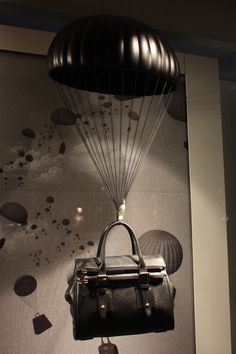 a handbag hanging from the side of a wall with parachutes on it's back