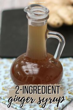 two ingredient ginger syrup in a glass carafe on a floral napkin with text overlay that reads, 2 ingredient ginger syrup