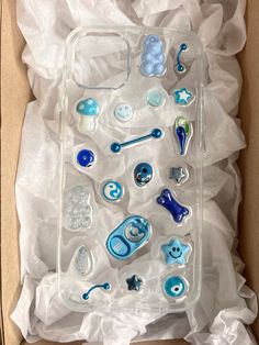 an open box with various blue and white items in it's packaging on top of tissue paper