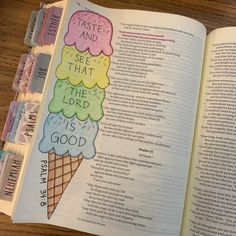 an open bible with ice cream cones on the pages and words written in different colors