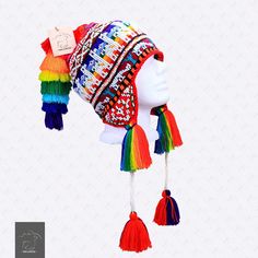 "FREE SHIPPING This colorful Chullo is a handmade hat made by indigenous from the Andes in Pisac Cusco - PERU, woven in multicolored wool yarn, with ear flaps and decorated with beads all around, which are sewn one by one. This particular one has a design of the \"Andean Llama\",South American camelid from the Andean cultures. If laid flat, the Chullo alone is approximately 12\" long x 10.5\" wide. Including the pompoms on the bottom and all of the top, it measures from end to end 30\" approxima Wool Gifts, Cusco Peru, Handmade Hat, Knitting Charts, Beautiful Hats, Alpaca Wool, Earmuffs, Sheep Wool, How To Make Ornaments