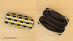 two purses sitting on top of a wooden table next to each other, one in black and yellow