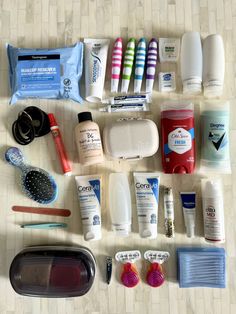 an assortment of personal care items laid out on a table with toothbrushes and other hygiene products