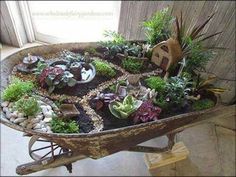 a wheelbarrow filled with lots of plants