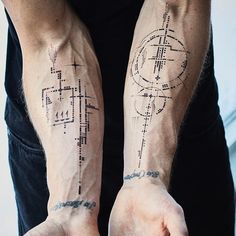 two people with tattoos on their arms