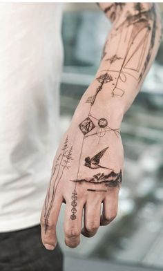 a man with tattoos on his arm and hand