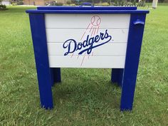 a dodgers sign sitting on top of a lush green field