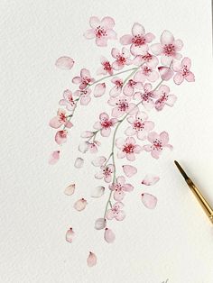 a watercolor painting of pink flowers on white paper with a fountain pen next to it