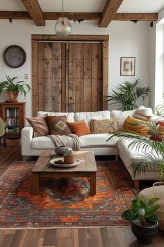 a living room filled with lots of furniture and plants on top of a wooden floor