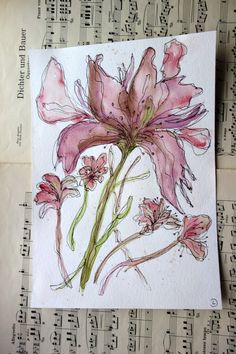 a watercolor painting of pink flowers on sheet music