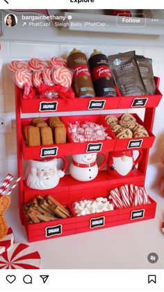 a red shelf filled with lots of candy canes and cookies on top of it