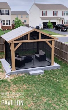 a backyard gazebo in the middle of a yard