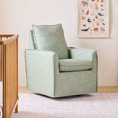 a baby's room with a rocking chair, crib and pictures on the wall