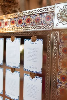 an ornately decorated mirror with place cards on it