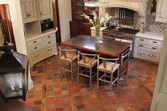 a kitchen with an oven, table and chairs