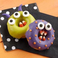 two donuts decorated to look like monsters