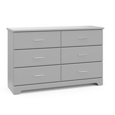 a grey dresser with four drawers and two doors on the bottom, in front of a white background