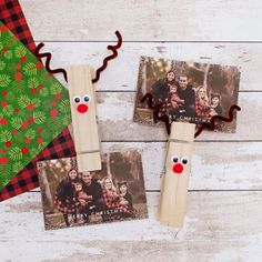 two christmas photo frames with reindeer noses on them and a wooden stick sticking out of it