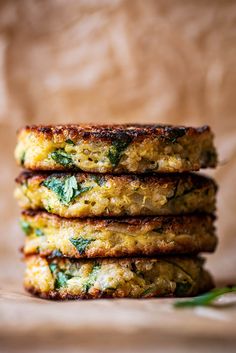 three fritters stacked on top of each other with herbs in the middle,