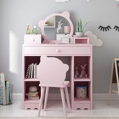 a pink desk with a mirror on top of it next to a shelf and chair