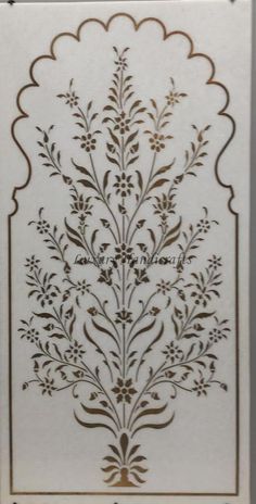 the back side of a card with an intricate design on it, in gold and white