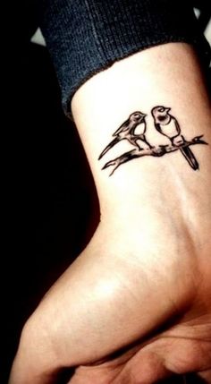 two birds on a branch tattoo on the wrist