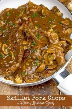 a white plate topped with meat covered in gravy