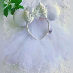 a white dress and headband with flowers on it