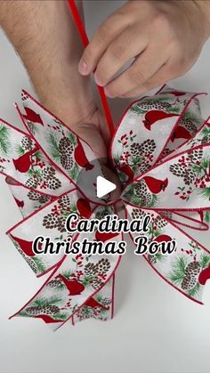 someone is making a christmas bow out of paper