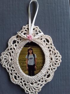 an ornament hanging on the side of a door with a photo in it