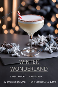 a white chocolate drink in a coupe glass with a candy cane on the rim, surrounded by snowflakes and christmas lights