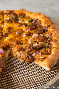 a pizza sitting on top of a metal pan next to a slice missing from it