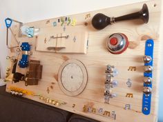 a wooden board with many different types of clocks and other things on it, including screwdrivers