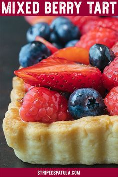 mixed berry tart with berries and blueberries on top