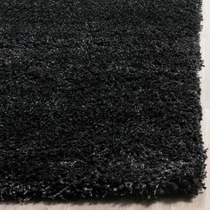 black shaggy rug on wooden floor in living room