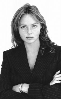 a black and white photo of a woman with her arms crossed