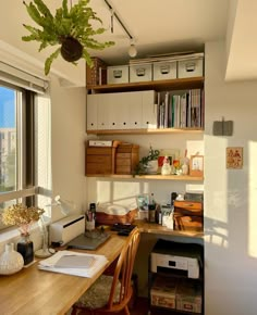 a home office with wooden desk and shelves filled with books, papers, and other items