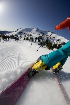 a person riding skis down a snow covered slope