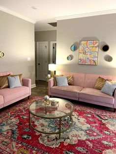 a living room with two couches and a coffee table in front of a doorway