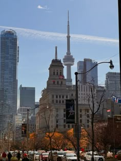 the city skyline has tall buildings and cars parked on the street in front of it