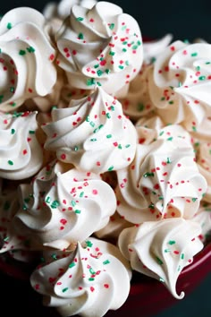 a red bowl filled with white and green sprinkles