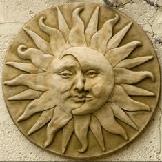 a sun face on the side of a building