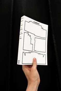 a hand holding up a piece of paper with a map in the middle on it