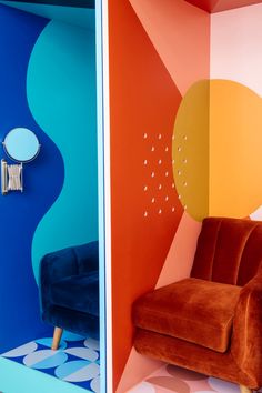 a colorful room with a chair and mirror