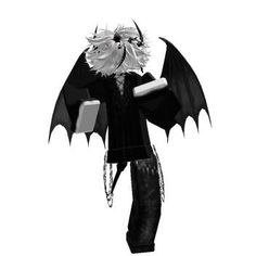 a black and white photo of a person dressed as a demon with wings on his head