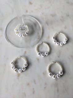 three wine glasses and four personalized beaded bracelets