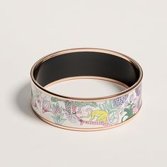 Wide bangle in "Precious Paradise" printed enamel with rose gold-plated hardware. This design by Katy Scott is an abundant conception of fauna and flora around two fountains. Animals hidden amidst a jungle of vegetation adorn our larger models. Our extra-narrow model is subtly floral. Made in France Fauna And Flora, Animal Hide, Orange Boxes, Cleaning Jewelry, Rose Gold Plates, Made In France, Original Box, Paradise