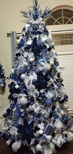 a blue and silver christmas tree with ornaments